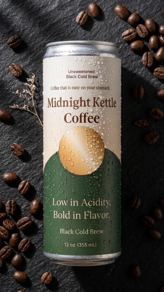 A 12 oz can of Midnight Kettle Coffee black cold brew, featuring a cream and green label with a gold kettle graphic, set against a dark slate background scattered with coffee beans.